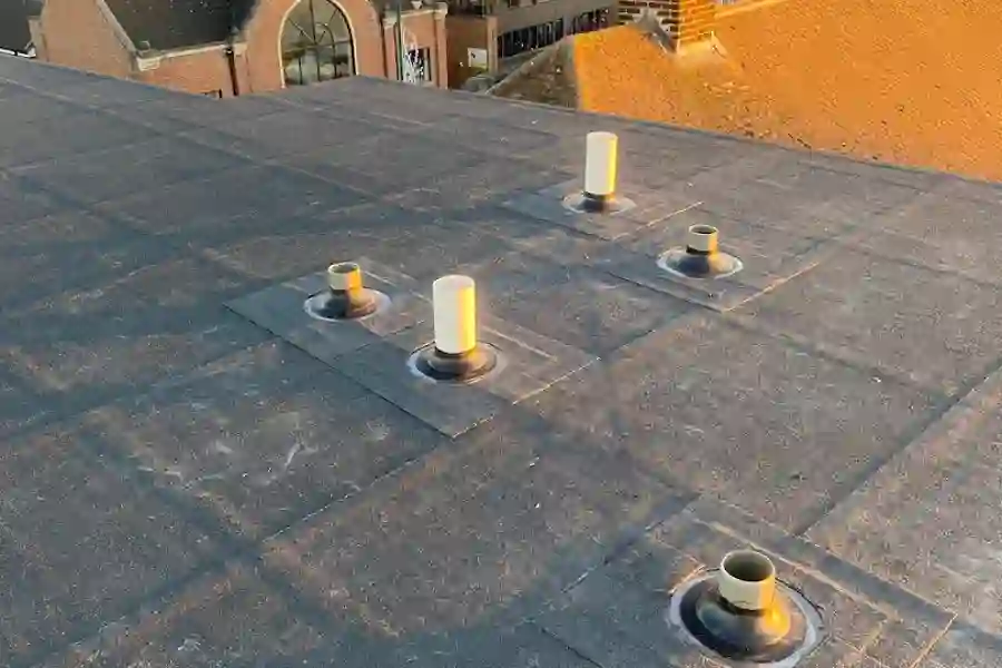 Finished flat felt roof with new vent pots, view across Essex at sunset